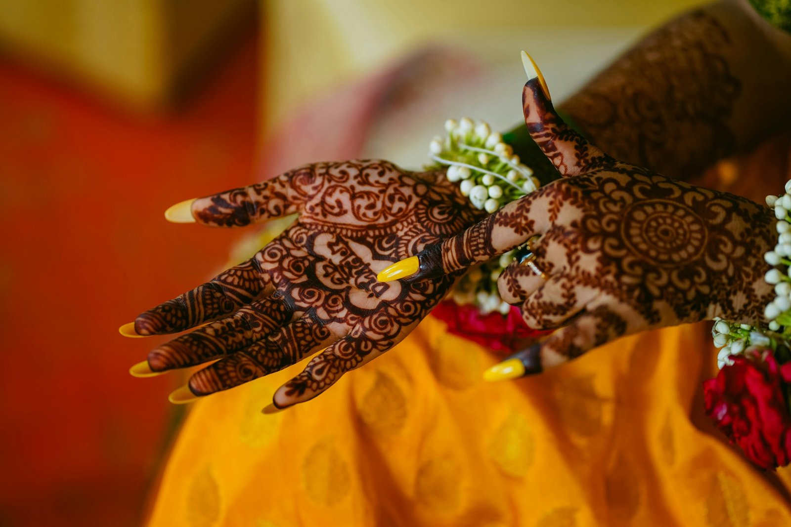 Detailed mehndi design on bride's hands with vibrant floral elements in Bangladesh.